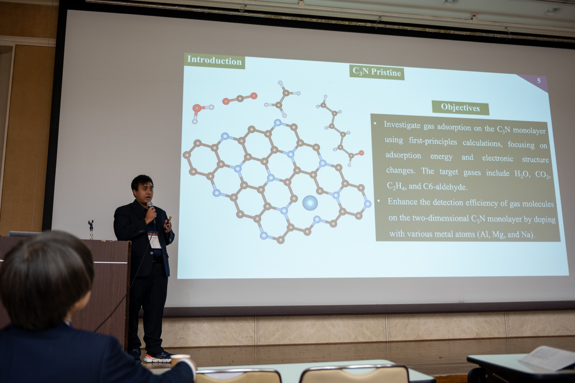 Researcher presenting first-principles gas-sensing research on C3N at ACCMS-11