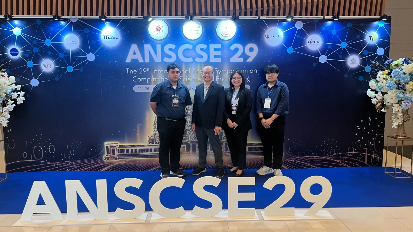 Computational Materials Unit members at the ANSCSE29 conference backdrop